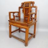 A Chinese hardwood open arm chair, with carved back