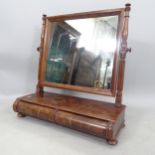 A Regency flame veneered mahogany toilet mirror, with 2 barrel turned short drawers, on bun feet,