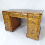 An early 20th century oak pedestal desk, with 9 fitted drawers and leather skiver, 122cm x 75cm x
