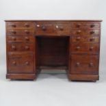 A 19th century mahogany kneehole writing desk, with 11 fitted drawers, 130cm x 85cm x 53cm (with