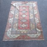 A modern salmon ground Afghan design rug, 300cm x 200cm