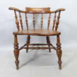 A 19th century elm-seated smoker's bow-arm chair Left arm A/F