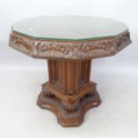 An Antique Continental oak centre table, with parquetry style octagonal top, allover relief carved