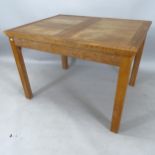 A 1930s Heals design oak draw leaf dining table, with single spare leaf, length 108cm extending to
