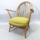 A mid-century Ercol beech low armchair, with original seat