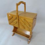 A reproduction teak cantilever sewing box