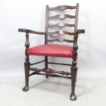 An Antique style ladder-back armchair, with red leather seat