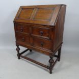 A 1920s oak 2-drawer bureau, 74cm x 100cm x 42cm