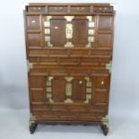 A Chinese elm 2-section cabinet, with 4 short frieze drawers, panelled cupboards and brass mounts,