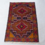 A red ground Baluchi rug, 137cm x 87cm