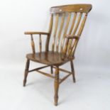 A Victorian oak and elm-seated Windsor kitchen armchair