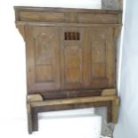 An Antique 17th century style oak double bed, with carved and panelled decoration, head board