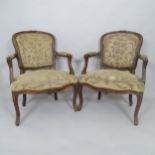 A pair of French walnut and upholstered open armchairs