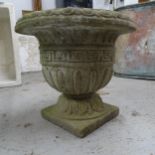 A weathered concrete garden urn, 41cm x 38cm