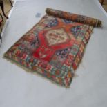 A red ground Afghan runner with figural decoration, 370cm x 108cm