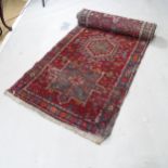 A red ground Persian runner, 350cm x 86cm