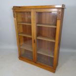 A 1930s oak 2-door bookcase, with 3 adjustable shelves, 105cm x 135cm x 28cm