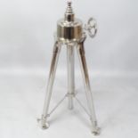 A chrome tripod base with adjustable legs