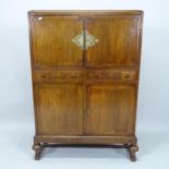 A 1920s oak 4-door cabinet, with 2 fitted drawers, 91cm x 132cm x 41cm (with key)