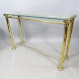 A Hollywood Regency style brass console table, with glass top, 115cm x 75cm x 34cm