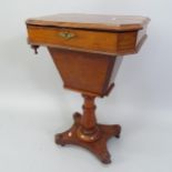 A 19th century mahogany sewing table, with lifting top, and turned centre column on platform base,