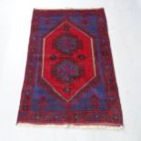 A red ground Baluchi rug, 143cm x 93cm