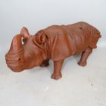 A carved wooden sculpture of a rhino, L110cm (WITH THE OPTION TO PURCHASE THE FOLLOWING LOT)