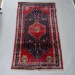 A red ground Afghan rug, 185cm x 105cm