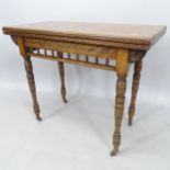 An Edwardian, Edwards & Roberts, mahogany rectangular fold over card table, with spindle turned