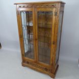 A JC Furniture oak bookcase, with leadlight glazed doors, adjustable glass shelves with drawer