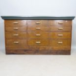 An early 20th century mahogany bank of 16 drawers, with painted wooden top, 153cm x 84cm x 52cm