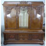 A large 2-section Continental oak cabinet, with glazed and quarter panelled cupboard doors, base