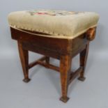 An Arts and Crafts mahogany rise and fall piano stool, with embroidered seat, on square tapered