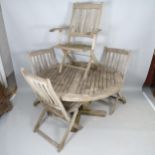 A weathered teak circular-topped garden table, with 5 matching chairs, with label for F. Peart &