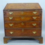 A George III oak bureau, with fitted interior and 4 long graduated drawers, on bracket feet, 83cm
