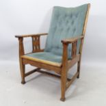 An Antique oak and upholstered Arts and Crafts open armchair, on square tapered legs