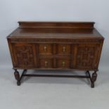 A Jacobean style oak bureau, with fitted drawers and cupboards, on baluster legs, 136cm x 102cm x