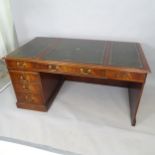 A reproduction mahogany centre-standing writing desk, with 5 fitted drawers, and 3 inset tooled