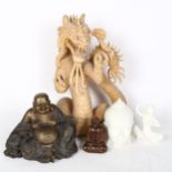A Chinese carved dragon, a modern concept Buddha figure, a carved wood Buddha figure, and a