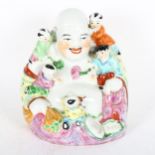 A Chinese famille rose laughing Buddha, with 5 figures of children, height 26cm