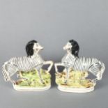 A pair of 19th century Staffordshire pottery zebra figures, height 21.5cm