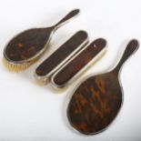 A George V silver and tortoiseshell 4-piece dressing table brush and mirror set, London 1919