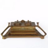 An Art Nouveau brass desk stand, with Griffon handles and removeable inkwells, width 36cm