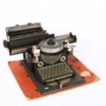 An early 20th century German tinplate toy Junior typewriter, circa 1920, by Gebruder Schmidt