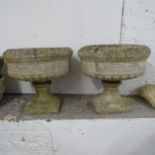 A pair of weathered concrete garden urns on stands, D44cm, H42cm