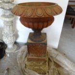 A pair of terracotta garden urns on stand, D47cm, height excluding plinth 70cm