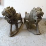 A pair of Oriental style carved stone lion sculptures, L70cm, H58cm