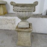 A weathered concrete 2-handled garden urn, W46cm, H43cm, and a square weathered concrete pedestal,