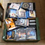 2 boxes of various DVDs