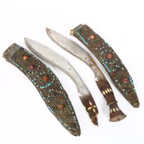 A pair of Indian kukri knives, with gem set brass-mounted scabbards and bone handles, blade length